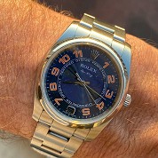 rolex modern 2007 oyster perpetual blue dial with orange color arabic numerals ref 114200 cal 3130 1