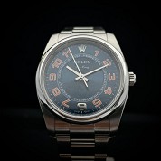 rolex modern 2007 oyster perpetual blue dial with orange color arabic numerals ref 114200 cal 3130 4